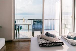 a living room with a balcony with a view of the ocean at Villa Lazar in Trpejca
