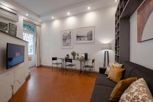 a living room with a couch and a table at Roman Forum Apartment - The Heart of Rome in Rome