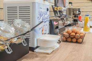 a food processor sitting on top of a counter with eggs at Esplanade Hotel in Diekirch