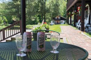 a table with three glasses and a can of beer at Innsbruck Inn at Stowe in Stowe