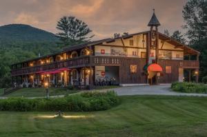 a large building with a clock tower in front of it at Innsbruck Inn at Stowe in Stowe