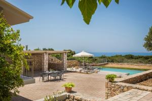 a villa with a swimming pool and a patio at Villa Ktima in Argostoli