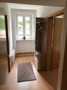 a room with a door and a window and a rug at FeWo "Biela", gemütlich, zentral, ruhig, Terrasse, Sandstein-Ferien, Familienfreundl in Königstein an der Elbe