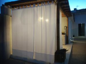 a white curtain on the side of a house at Casa Clementa in Pula