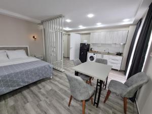 a bedroom with a bed and a table and chairs at Picasso in Shekhvetili