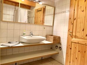 a bathroom with a sink and a mirror at Ferienwohnung 2 im Böhler Haubarg in Sankt Peter-Ording