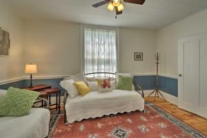 a living room with a chair and a window at Sodus Point Historic Home about half Mi to Sodus Bay! in Sodus