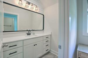 a bathroom with a sink and a large mirror at Luxe Lakefront Getaway with Porch and Water View! in Dadeville +33 photos
