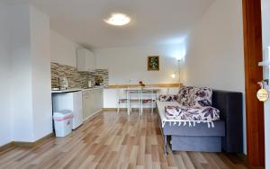 a living room with a couch and a kitchen at Apartment Stjepan in Rakovica
