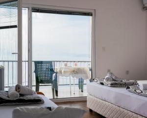 a room with two beds and a balcony with a view at Villa Lazar in Trpejca