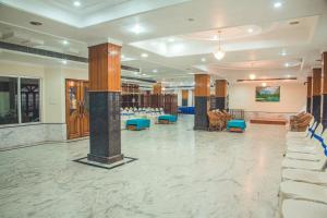 a large room with chairs and tables in a library at Hotel Priya Palace in Guwahati