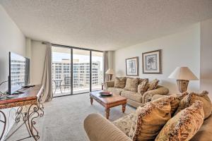 a living room with a couch and a table at Beachfront Marco Island Condo with Pool Access! in Marco Island