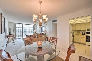 a living room with a glass table and chairs at Beachfront Marco Island Condo with Pool Access! in Marco Island