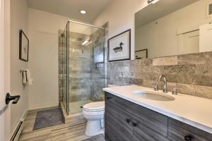 a bathroom with a shower and a toilet and a sink at Grand Lake Condo with Balcony and Mountain Views in Grand Lake