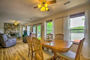 een eetkamer met een tafel en stoelen en een bank bij Lakefront Rocky Mount Retreat with Swim Dock! in Rocky Mount