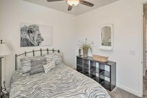 a bedroom with a zebra print bed and a mirror at Idyllic Kingman Retreat with Yard - Near Hiking in Kingman