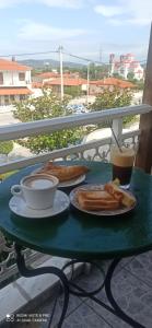 a green table with a cup of coffee and bread at Hotel La Strada in Tycherón +76 photos