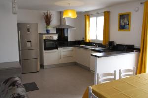 een keuken met een wastafel en een fornuis top oven bij Les lauriers de Lomagne in Lavit
