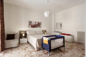 a white bedroom with a bed and a couch at Casa Lucia in Lecce +13 photos