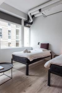 En eller flere senge i et værelse på CPH Studio Hotel