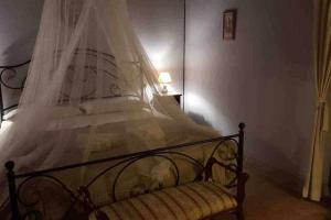 a bedroom with a bed with a veil on it at Il Borghetto di Pedana in Città di Castello