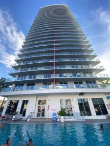 a large building with a swimming pool in front of it at BeachWalk 1B-1B Apmt Amazing View 12A in Hallandale Beach
