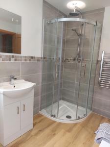 a shower with a glass door in a bathroom at Two bedroom cottage - country lane -10 min walk to Perranporth beach in Perranporth +13 photos