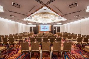 a large room with rows of chairs and a screen at ANA Crowne Plaza Kobe, an IHG Hotel in Kobe