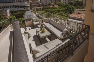 a balcony with a table and chairs on a building at Luxury house Lucija in Dugi Rat
