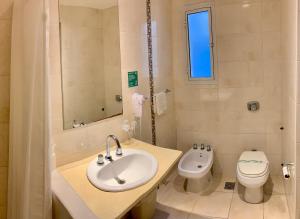 a bathroom with a sink and a toilet at Hotel Select in Mar del Plata