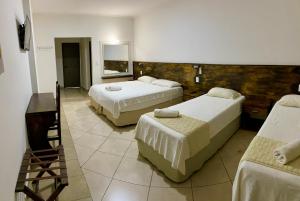 Llit o llits en una habitació de Rainforest Hotel & Cabañas
