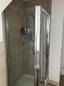 a shower with a glass door in a bathroom at Smith's Loft in Chichester +9 photos