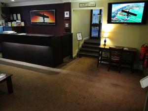 a restaurant with a bar with a television on the wall at The Angel View Hotel in Gateshead