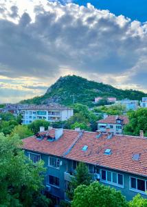 a group of houses with a mountain in the background at Luxury Apartments Ivon in Plovdiv