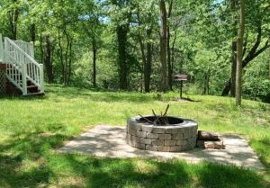 a fire pit in the middle of a grass field at Wisconsin Dells Cabin in the Woods - VLD0423 in Wisconsin Dells +7 photos