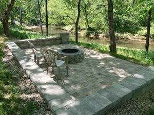 a patio with two chairs and a fire pit at Wisconsin Dells Cabin in the Woods - VLD0423 in Wisconsin Dells