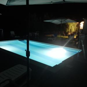 a swimming pool lit up at night at LA CASA DI GIORGIO in Lamezia Terme