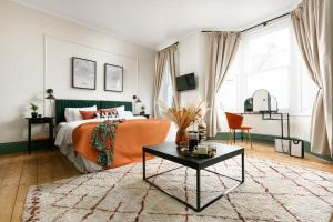 - une chambre avec un lit et une couverture orange dans l'établissement NEW LUXURY for 2022 - Central Plymouth House - Sleeps 10 - Access to Plymouth Hoe - Close to The Barbican - Pets welcome - By Luxe Living, à Plymouth