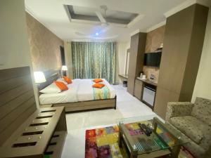 a bedroom with a bed and a living room at Hotel Sagar in Guwahati