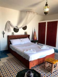 a bedroom with a large bed in a room at Tigmi surf morocco in Tiguemmi nʼAït Bihi