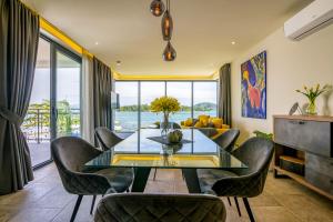 a dining room with a glass table and chairs at Bonaventura Residence in Murter
