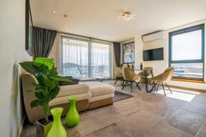 a living room with a couch and a table at Bonaventura Residence in Murter