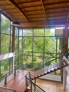 a staircase in a room with large windows at Rainforest Hotel & Cabañas in Puerto Iguazú