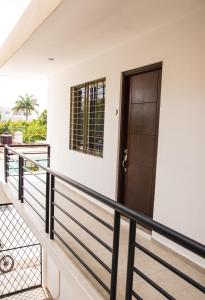 a balcony with a black door and railing at Departamento Orellana 9 in Chetumal