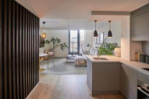 an open kitchen and living room with a dining room at Leven Manchester in Manchester