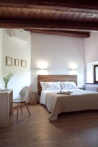 a bedroom with a large bed and a chair at Il borgo Casteldelci in Casteldelci +92 photos