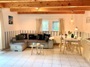 a living room with a couch and a table at Ferienwohnung 5 im Böhler Haubarg in Sankt Peter-Ording