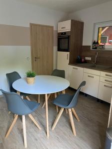 a kitchen with a table and chairs in a room at Ferienhaus Pepe in Graal-Müritz