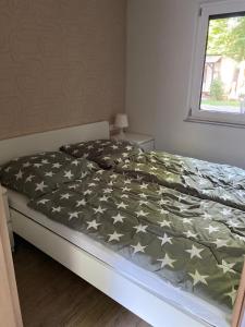 a bedroom with a bed with stars on it at Ferienhaus Pepe in Graal-Müritz