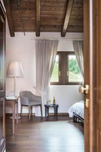 a bedroom with a bed and a chair and a table at Orsone B&B in Gagliano